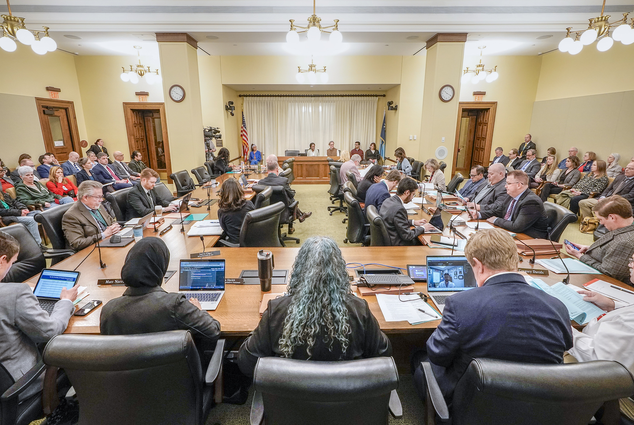 The House Taxes Committee and a capacity crowd listen April 9 as Rep. Esther Agbaje and Rep. Danny Nadeau present a bill to extend and increase the current sales tax in Hennepin County to help fund health care facilities. (Photo by Andrew VonBank)